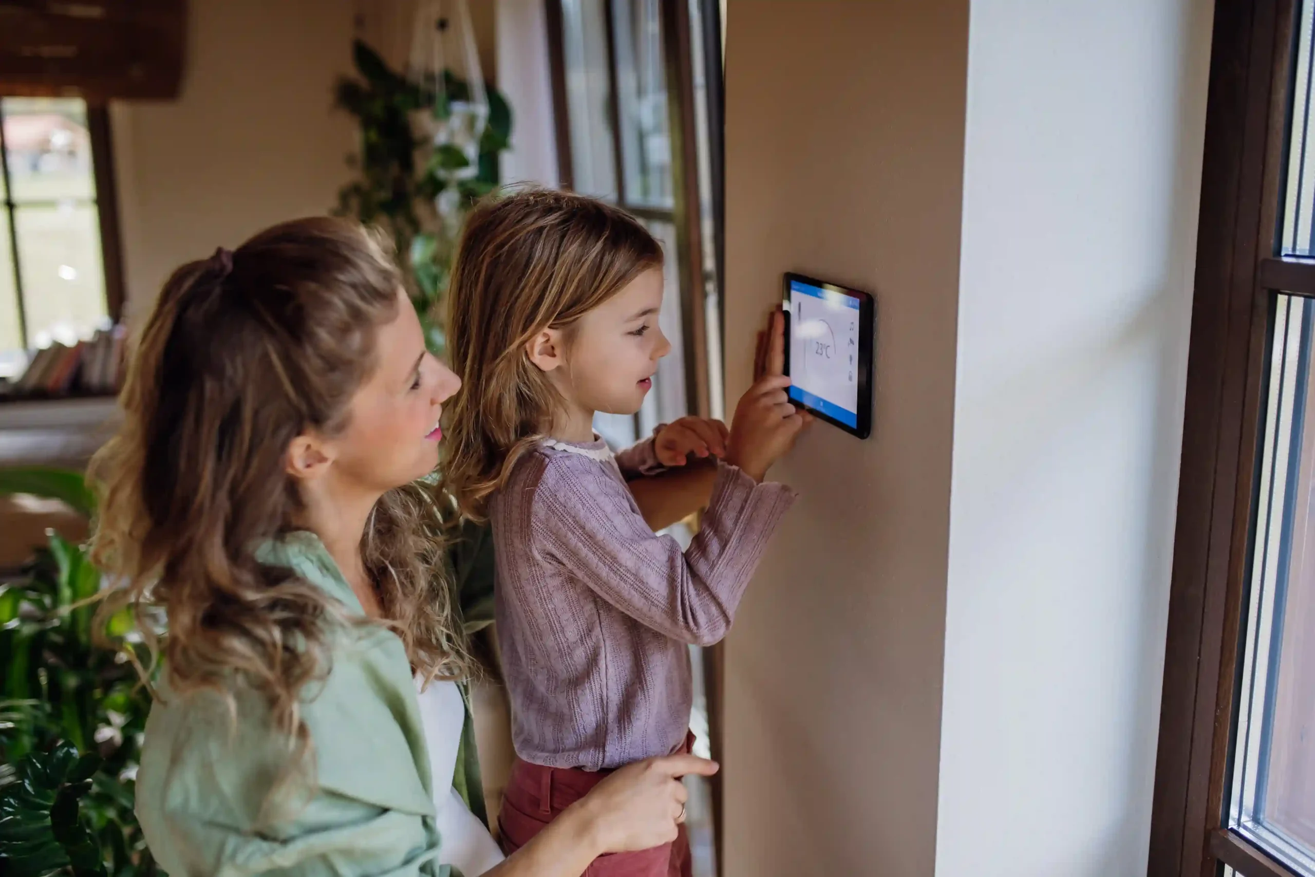 Child interacting with a device while parent watches