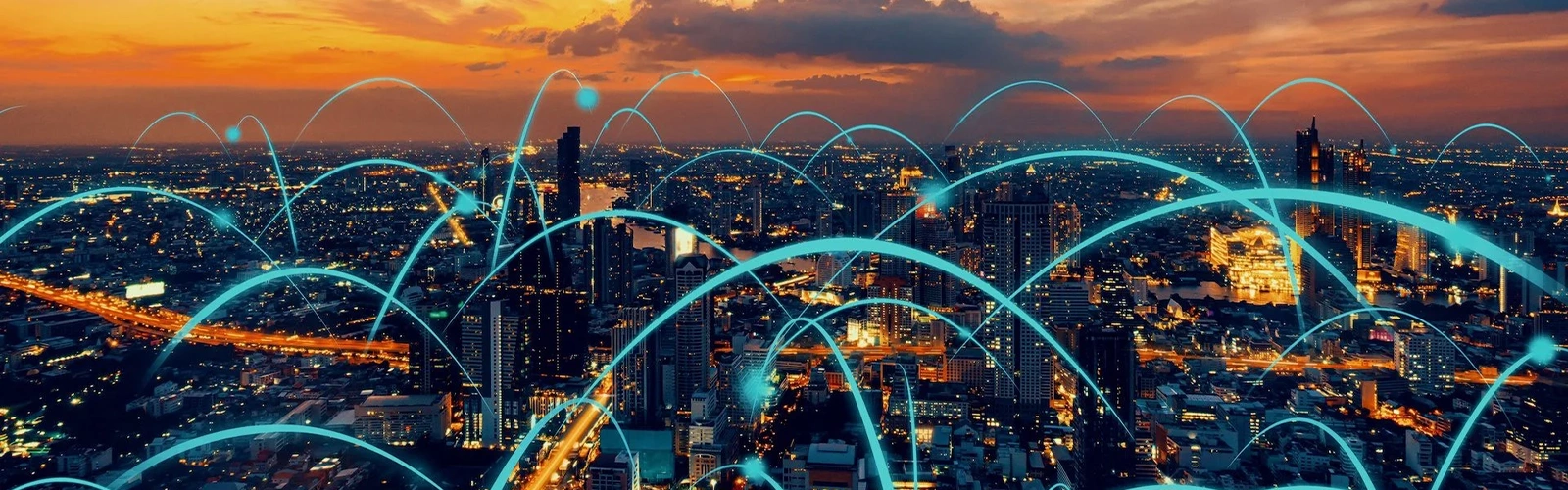City skyline with digital connection lines at sunset.