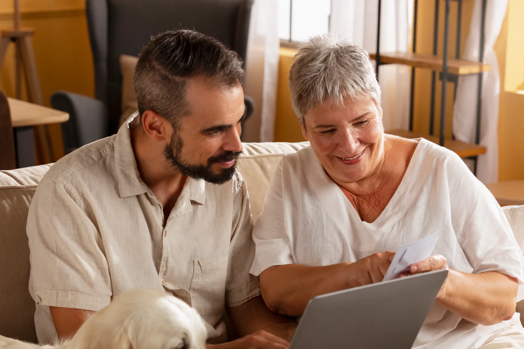 Two people enjoying time together with a laptop.
